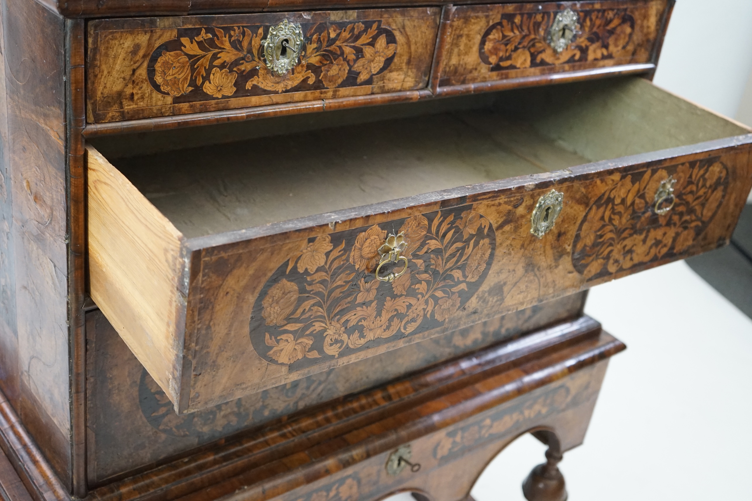 A William and Mary walnut and marquetry chest on stand